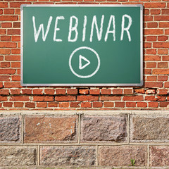 Education theme. Ancient brick wall with WEBINAR title on a chalkboard