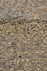 Stone wall texture.
Rough masonry. Vertical shot. Clutches of the top and bottom are different.
