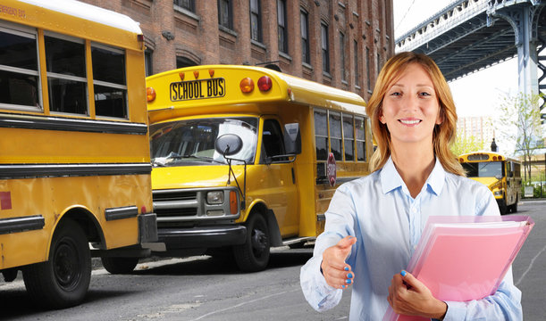 Woman teacher with school bus