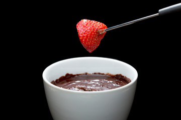 chocolate fondue with strawberry on a fork