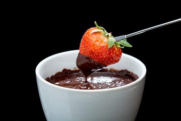 chocolate fondue with strawberry on a fork
