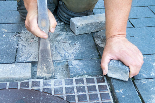 Working On The Street Lay Bricks And Sweep