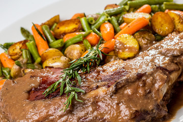 lamb shoulder blade with vegetables, potatoes and carrots finger-green beans, stewed with white wine sauce