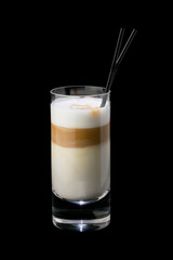 Iced coffee in a glass with a straw. On a black background