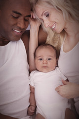 Cheerful interracial family cuddling