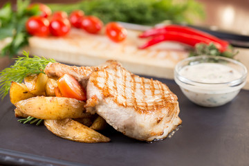 Pork with baked potatoes and mushroom sauce