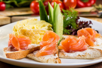 Skrembl of eggs. Toasts with cream cheese and salted salmon