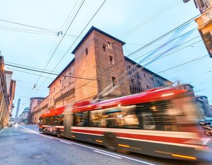 Red bus speeding up in Bologna streets at dusk © jovannig
