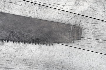 saw blade on a wooden background, black and white toning