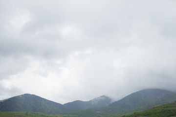 Mountains and mist under the grey sky
