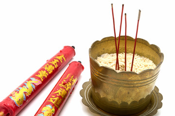 Incense sticks and candles in old golden incense burner .