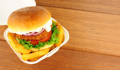 Chicken Sandwich And Fries In Take Away Box
