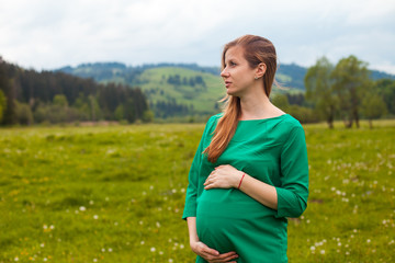 Pregnant woman in a green tunic