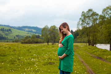 Pregnant woman in a green tunic