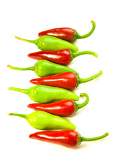 Many ripe red and green Chilli peppers on white