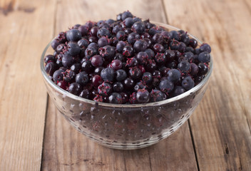 Shadberry in a glass bowl on the old wooden table