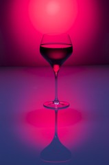 Redwine5/A glass of red wine on a red background