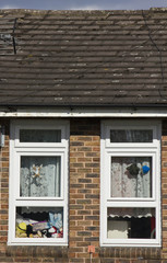 LONDON, UNITED KINGDOM - SEPTEMBER 12 2015: Close up of two window of a traditional british house, with puppets behind