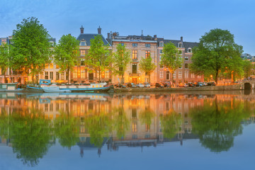Fototapeta na wymiar Panoramic view and cityscape of Amsterdam with boats, old buildings and Amstel river, Holland, Netherlands