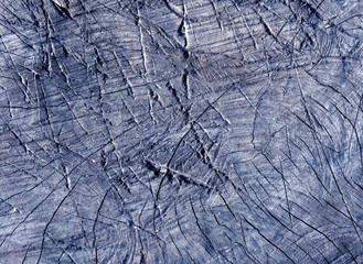 Abstract blue toned cut old tree surface with axe scratches.