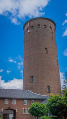 Fototapeta na wymiar water tower with side building and gate