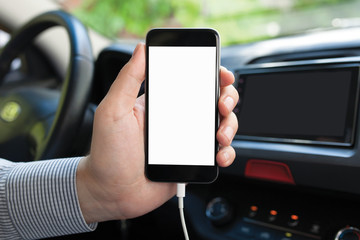 man sitting in saloon car holding in the hands phone