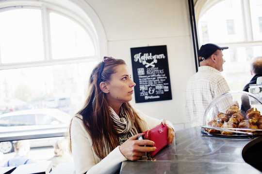 Businesswoman at checkout counter in coffee shop