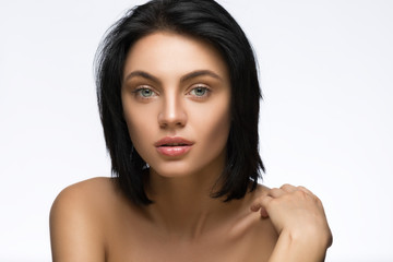 Beautiful young woman with straight short hair isolated on white background