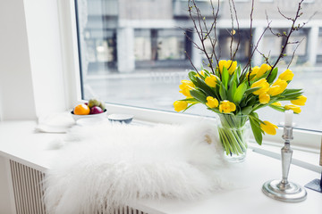Fur rug and flower vase on window sill