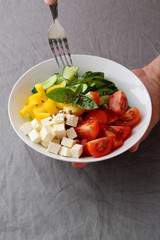 Fresh vegetables salad in white bowl