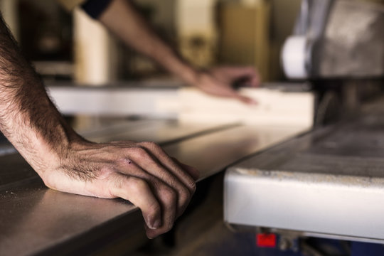 Carpenter working in workshop, close up of hands