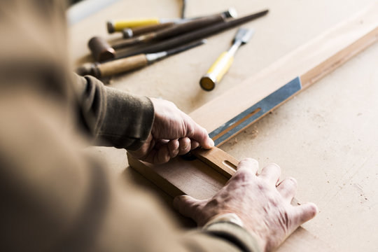 Cropped image of carpenter using sliding T bevel in workshop