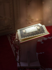 Священная для мусульман  книга  - Коран , на подставке.