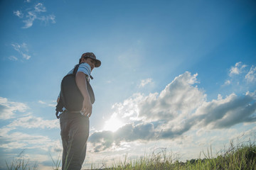 man travelling in nature with backpack