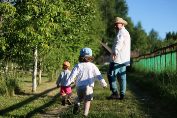 two kids walk grandfather