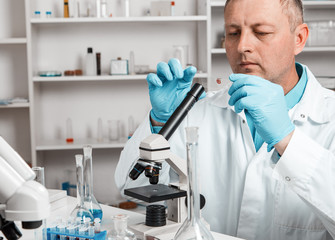 Fototapeta premium male scientific researcher using microscope in the laboratory.
