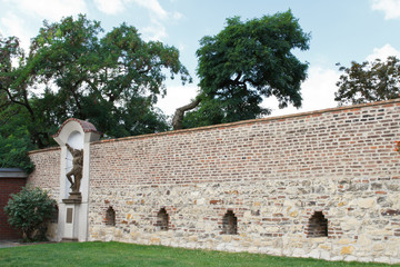 Wall in Visegrad decorated with a statue of St. Sebastian. Prague
