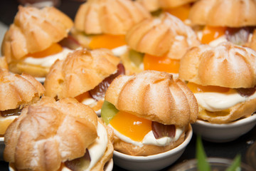 Eclair with whipped cream and fruit