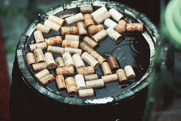 Bottle corks float in a barrel