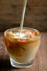 Iced coffee on wooden table