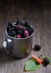 Mulberries on wooden background