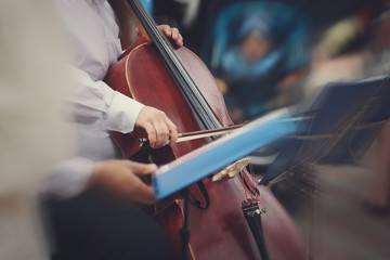 A blurred picture of a man playing the cello