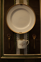 Tea service put in the frame and wedding rings put over spoons