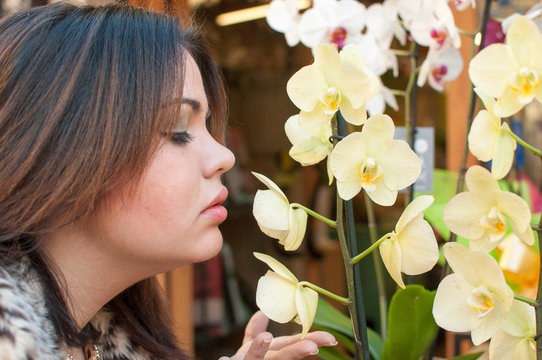 young woman smelling flowers