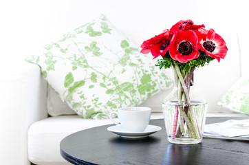 vase of red flowers in modern white living room - home decor