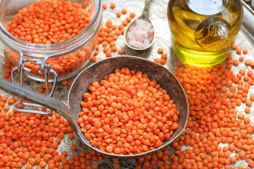 Orange lentils in an old metallic spoon