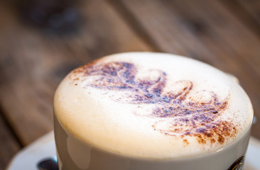 Latte art pattern on foam of coffee top view.