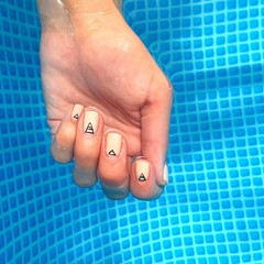 Fototapeta premium Girl's hand with fashion manicure in the swimming pool