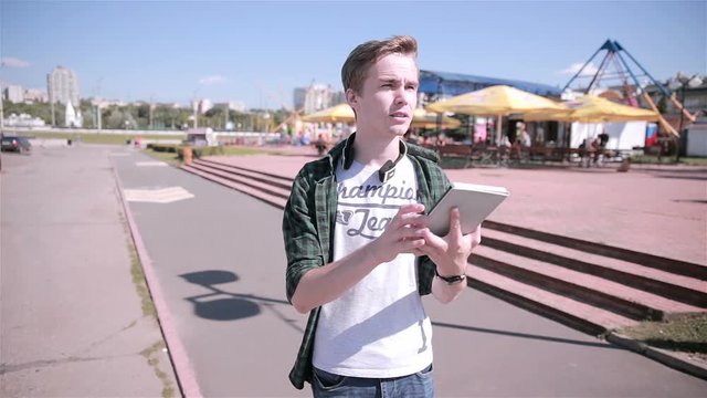 Young man looking at map on his tablet