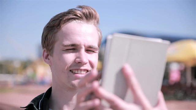 Young man looking at map on his tablet